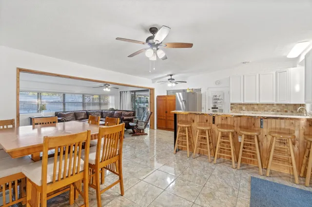 a very nice looking dining room with a large window and stainless steel appliances