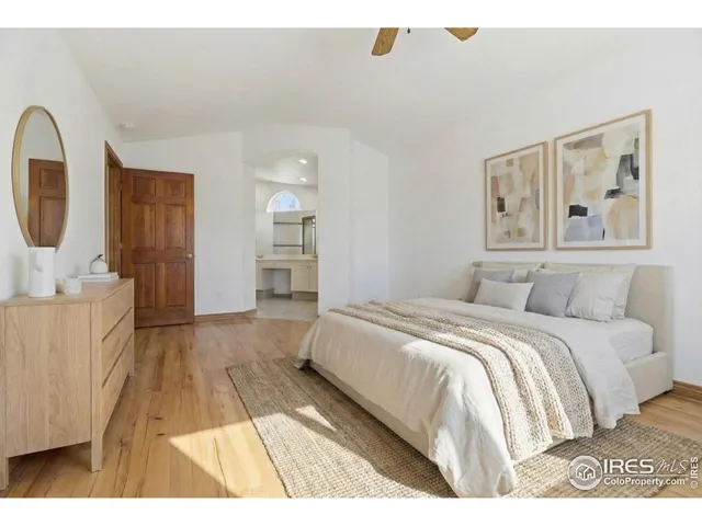 a spacious bedroom with a bed and cabinets