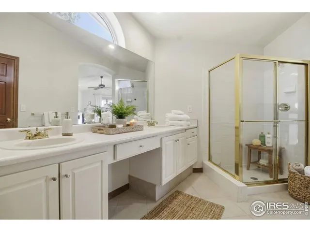 a bathroom with a sink a mirror and a shower
