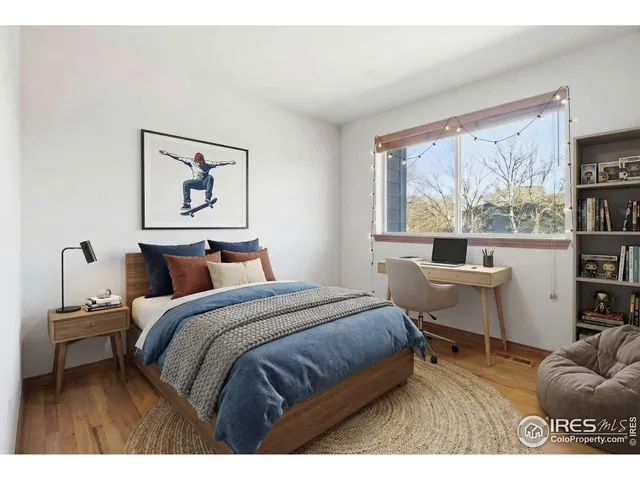 a bedroom with a bed and a large window