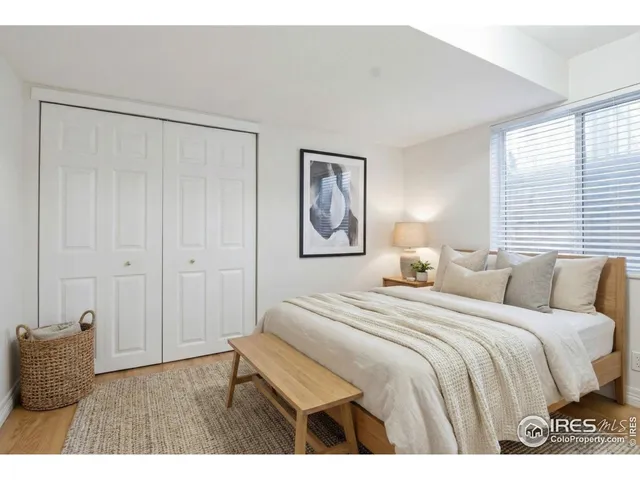 a bedroom with a bed and a painting on the wall