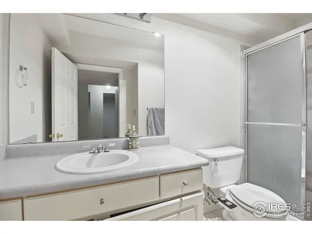 a bathroom with a sink toilet and mirror