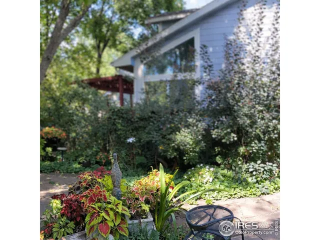 a backyard of a house with a yard and outdoor seating