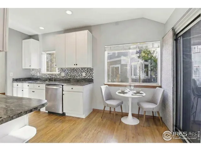 a living room with a sink and a large window