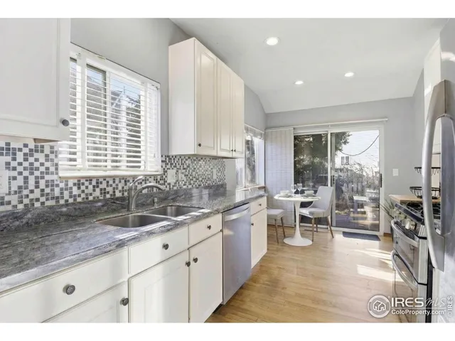 a kitchen with sink cabinets and dining table