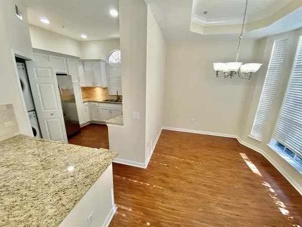 a bathroom with a sink a toilet a mirror and shower