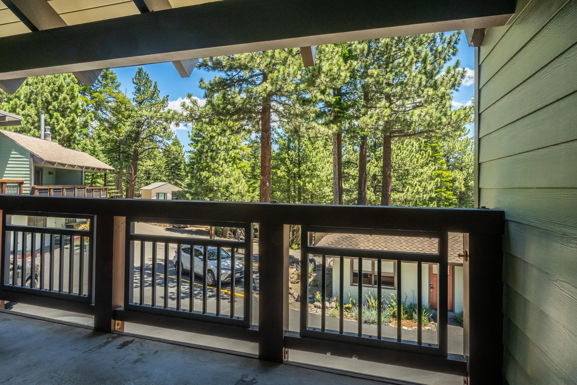 50 Hidden Valley Road, Unit 17 Mammoth Lakes, CA 93546 - Photo 23 of 40 Balcony featuring dark wood railing with metal balusters and a concrete floor