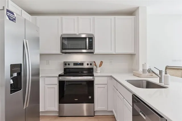 a kitchen with a sink stove and refrigerator