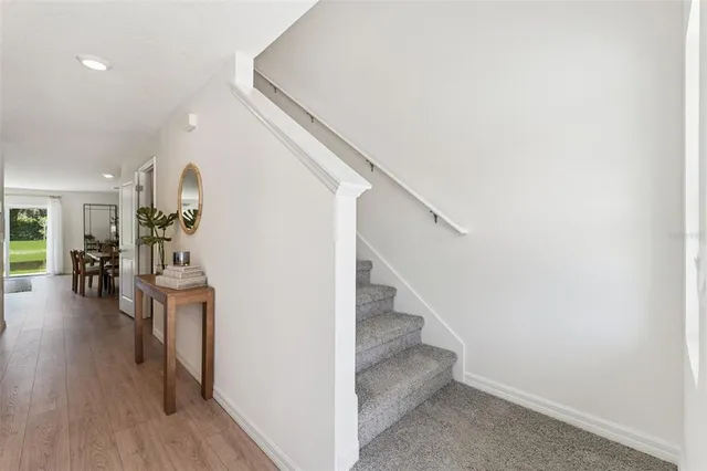a view of entryway and hall with wooden floor