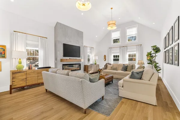 a living room with furniture a chandelier and a flat screen tv