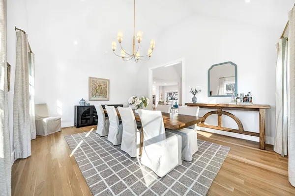 a living room with furniture a dining table and a fireplace