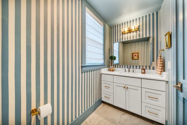 a bathroom with a double vanity sink and a mirror