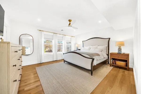 a bedroom with a bed and wooden floor