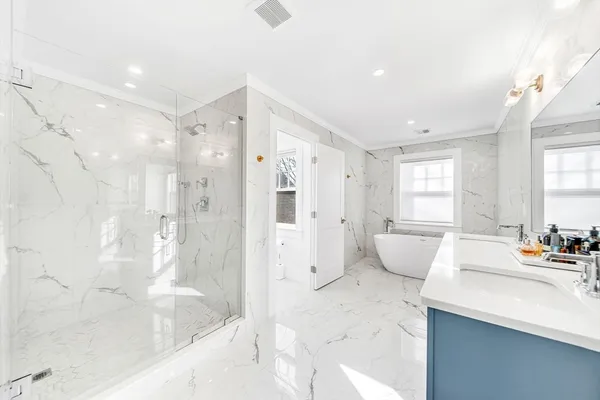 a spacious bathroom with a tub shower sink and mirror