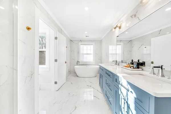 a large white room with mirror and sink