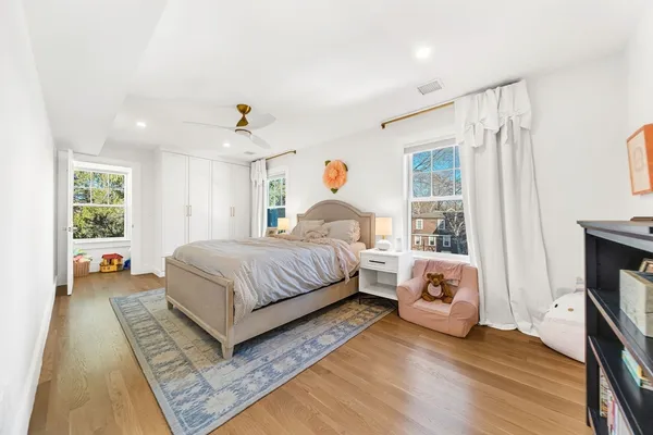 a spacious bedroom with a bed and a window