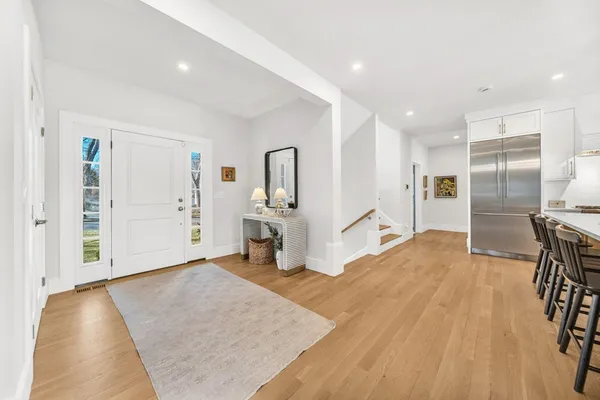 a view of a kitchen with furniture and a refrigerator