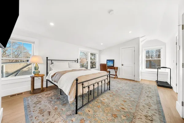 a bedroom with a bed and a view of living room