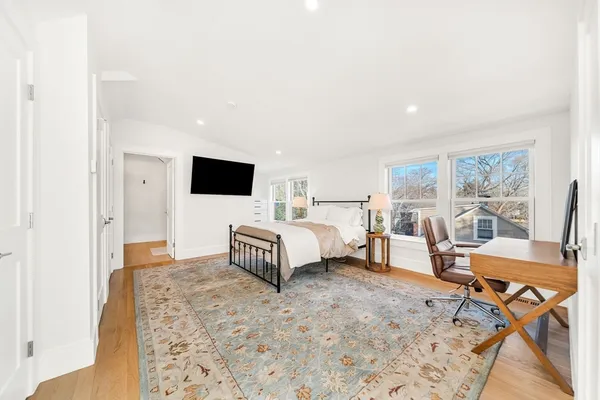 a spacious bedroom with a bed and large window