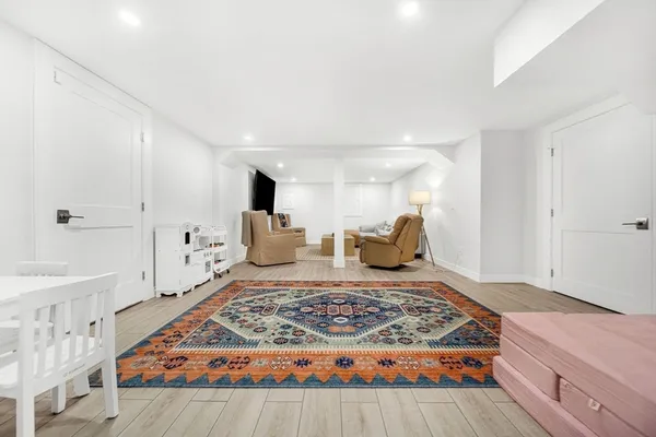 a bedroom with a large bed and a rug