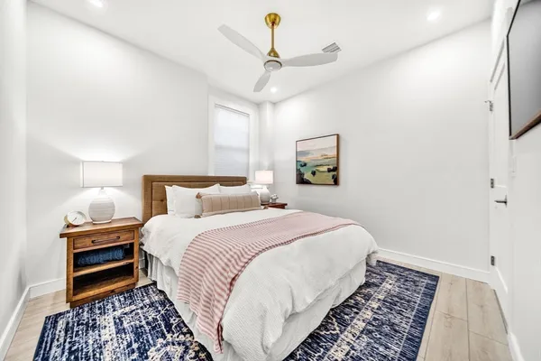 a bedroom with bed and a night stand