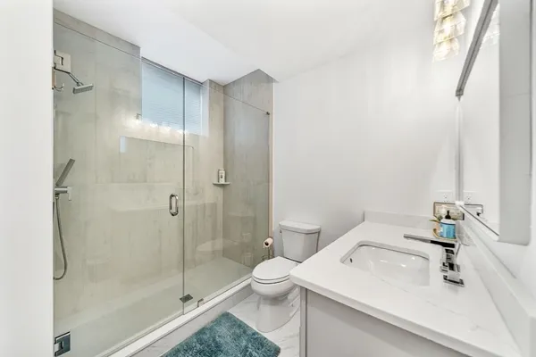 a bathroom with a sink toilet and shower