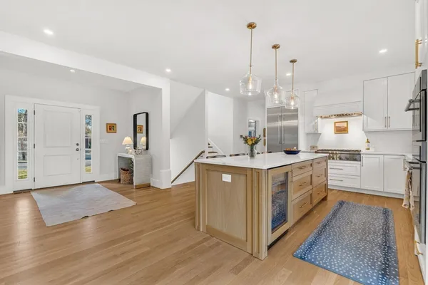 a kitchen with sink cabinets and wooden floor