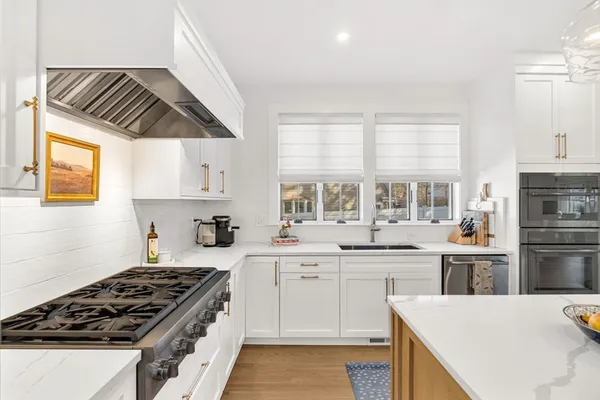 a kitchen with a stove a sink and a refrigerator