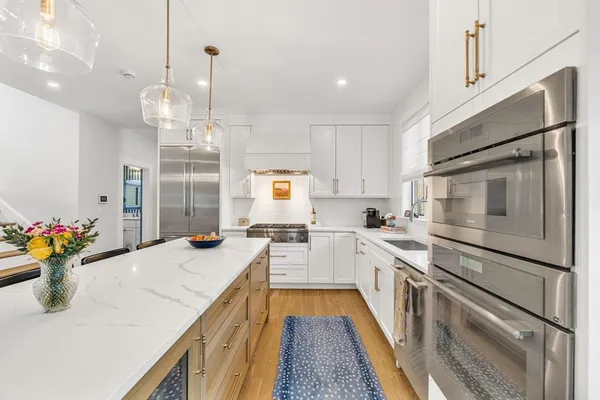 a kitchen with a sink stove and refrigerator