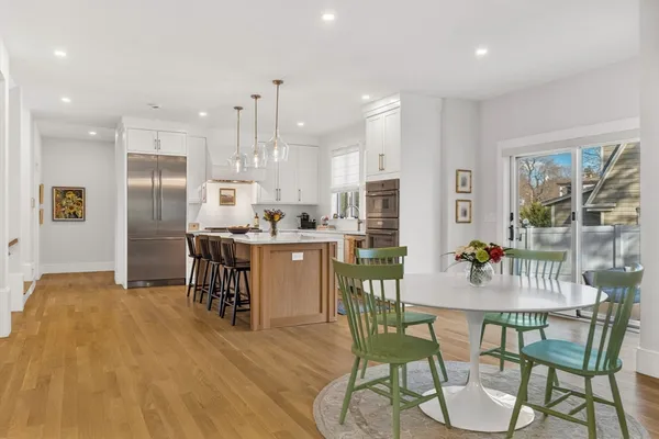 a dining room with furniture and a kitchen view