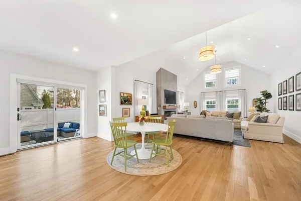 a living room with fireplace furniture and a wooden floor