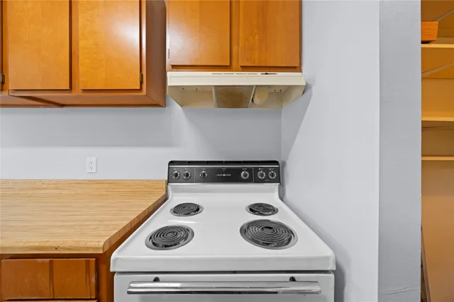 a stove top oven sitting inside of a kitchen