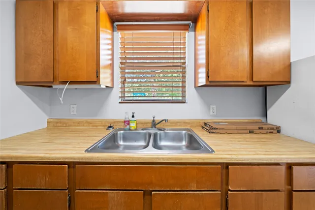 a kitchen with a sink and a window