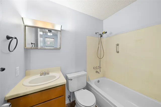 a bathroom with a toilet sink shower and mirror