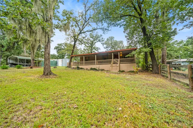 a view of a house with a backyard