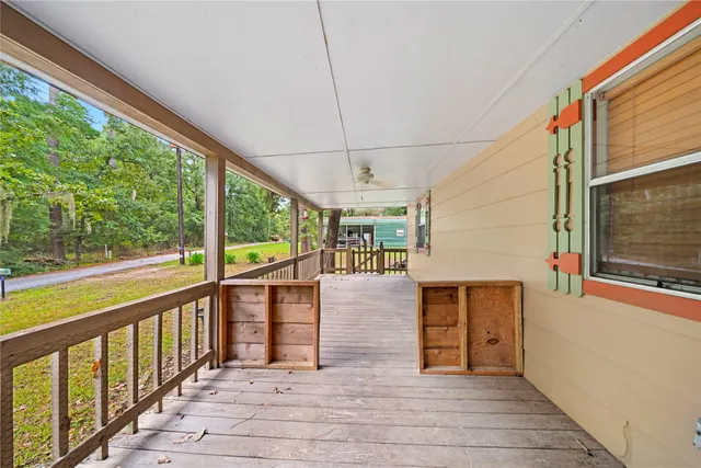 a view of a balcony with wooden floor and iron stairs