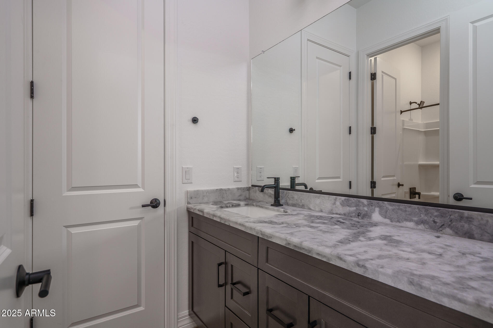 18575 West Sapium Way Goodyear, AZ 85338 - Photo 25 of 51 a bathroom with a granite countertop sink and mirror