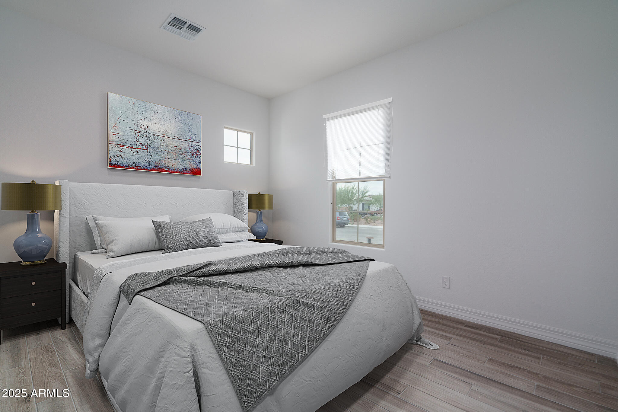18575 West Sapium Way Goodyear, AZ 85338 - Photo 27 of 51 a bed sitting in a bedroom next to a window