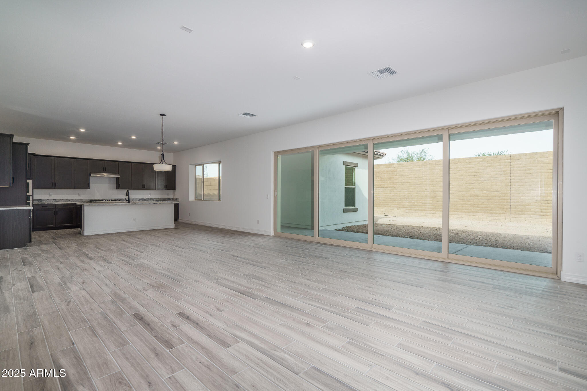 18575 West Sapium Way Goodyear, AZ 85338 - Photo 5 of 51 a view of a kitchen with a sink and a stove top oven
