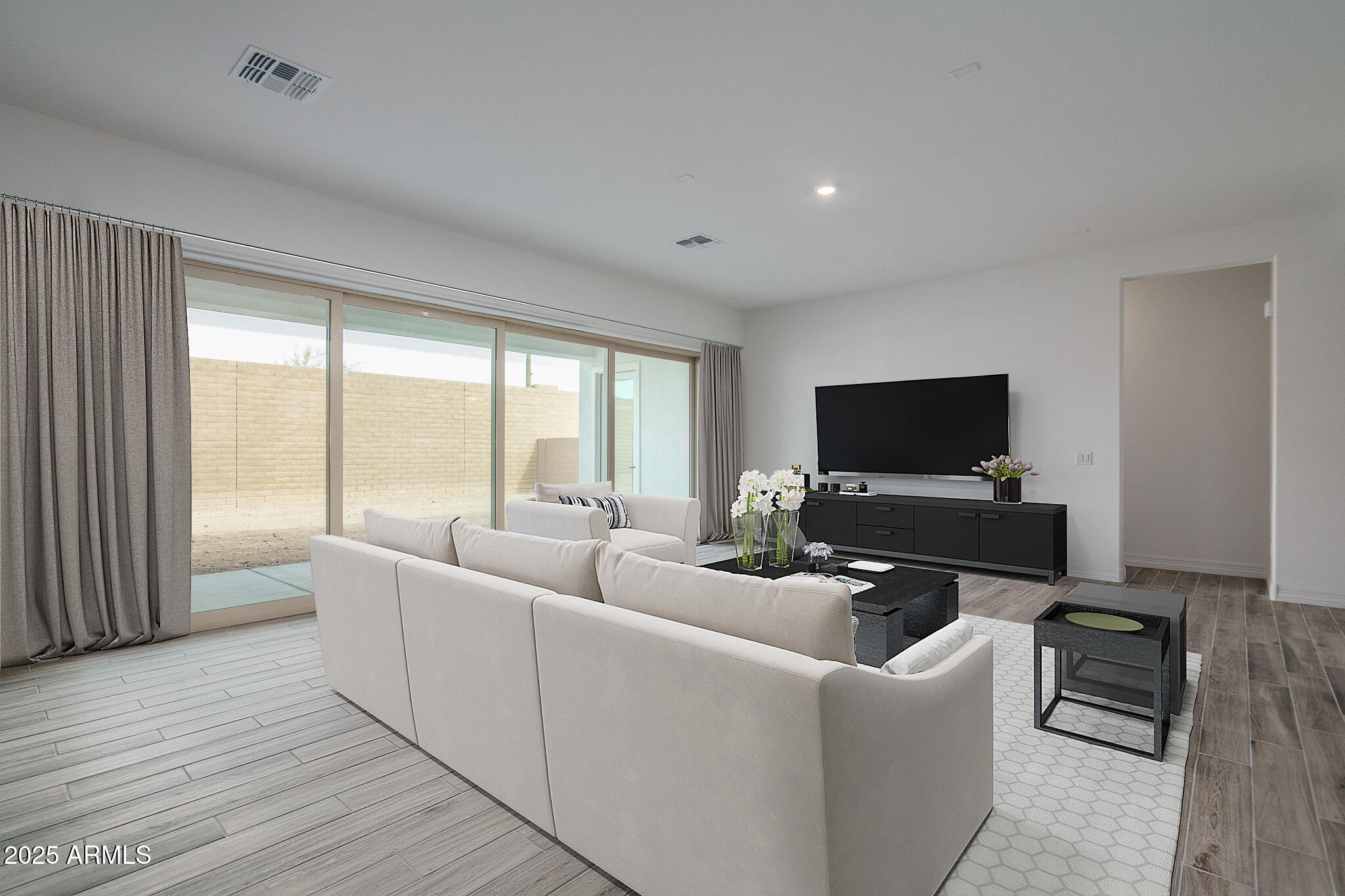 18575 West Sapium Way Goodyear, AZ 85338 - Photo 8 of 51 a living room with furniture and a flat screen tv