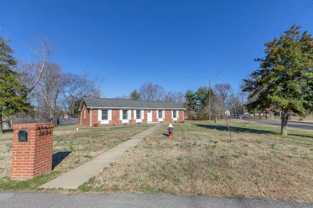 a living room with furniture and a ceiling fan