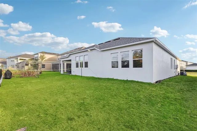 a view of a house with a yard and garage