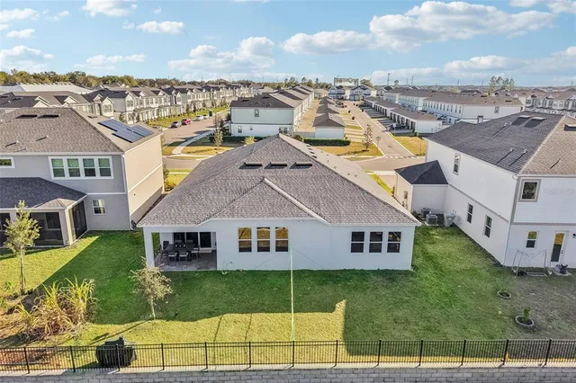 a view of a house with swimming pool and a yard