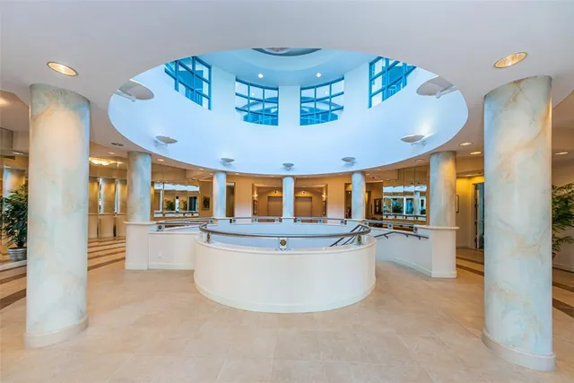 a bathroom with a granite countertop sink and a toilet