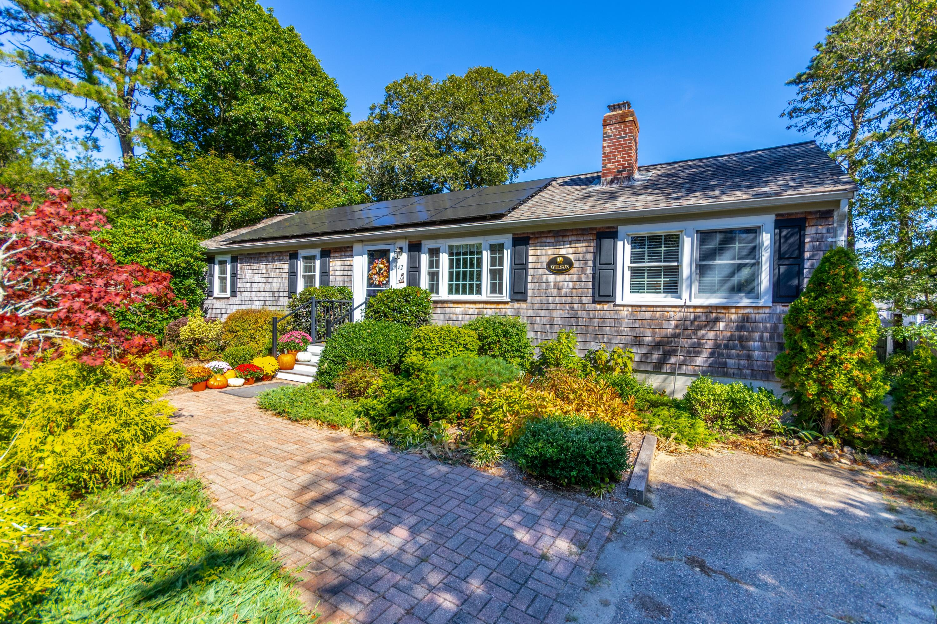 42 Agnes Road South Dennis, MA 02660 - Photo 1 of 36 a front view of a house with a yard and potted plants