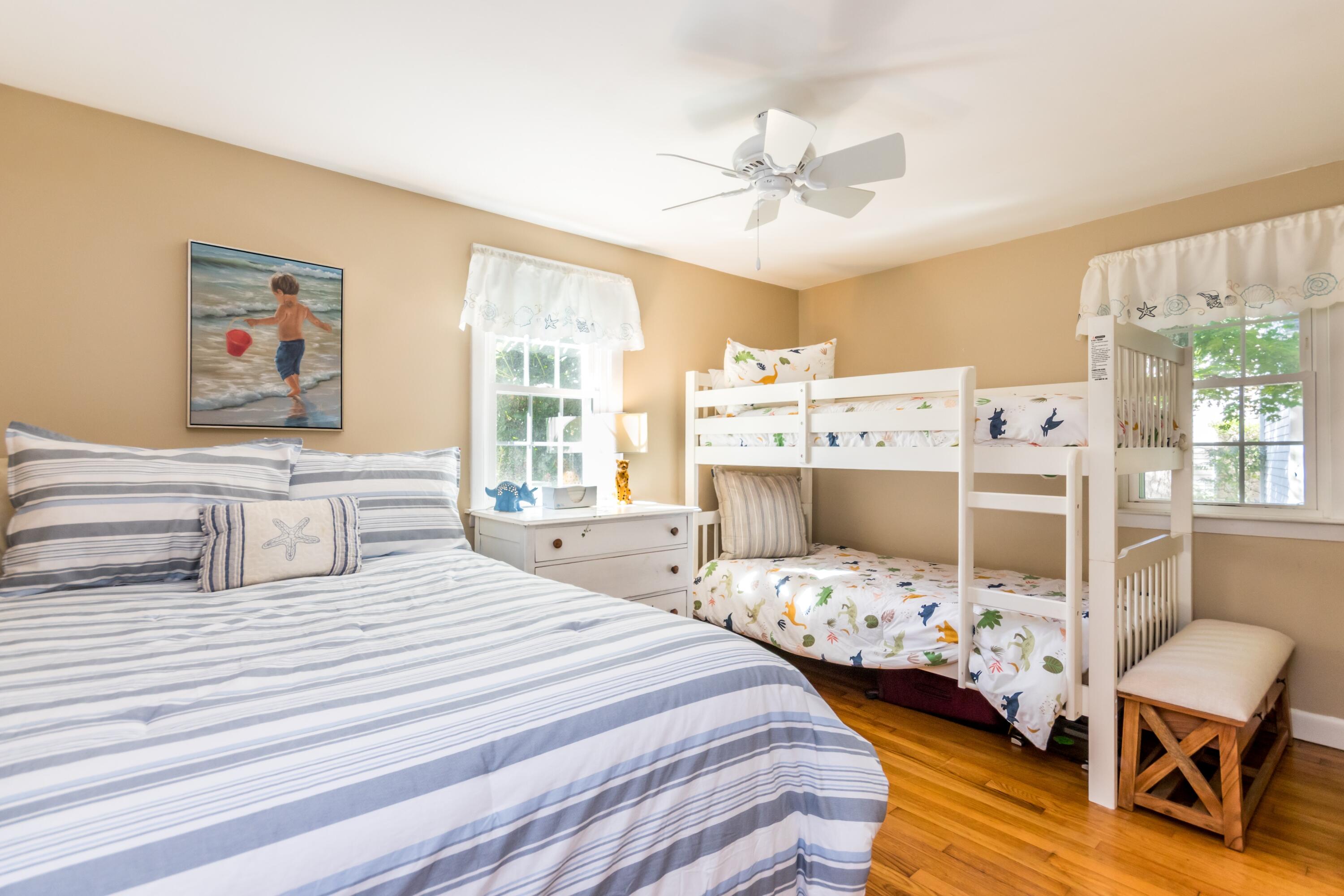 42 Agnes Road South Dennis, MA 02660 - Photo 19 of 36 a bedroom with a bed and a chandelier