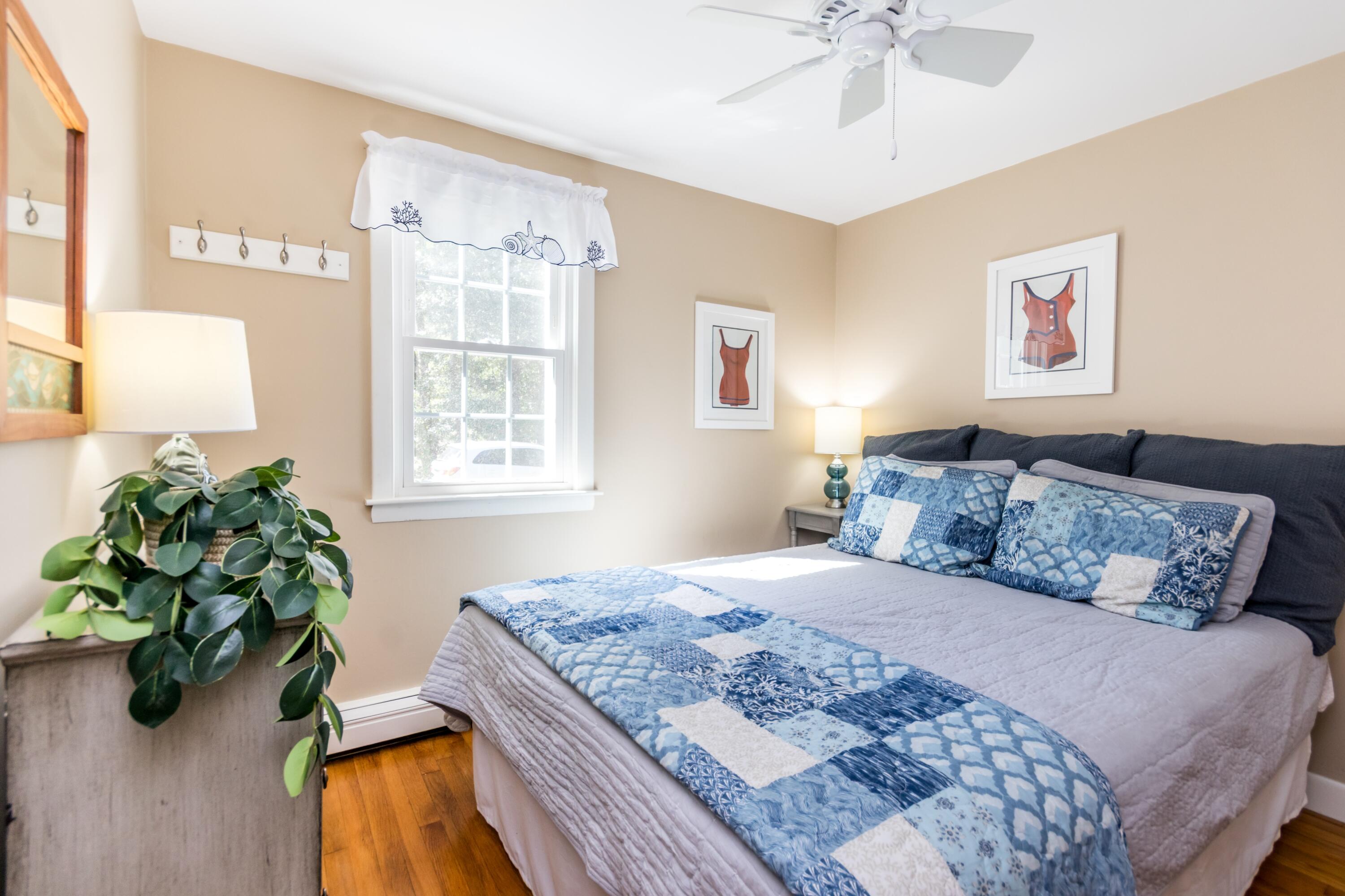 42 Agnes Road South Dennis, MA 02660 - Photo 20 of 36 a bedroom with a bed and a potted plant