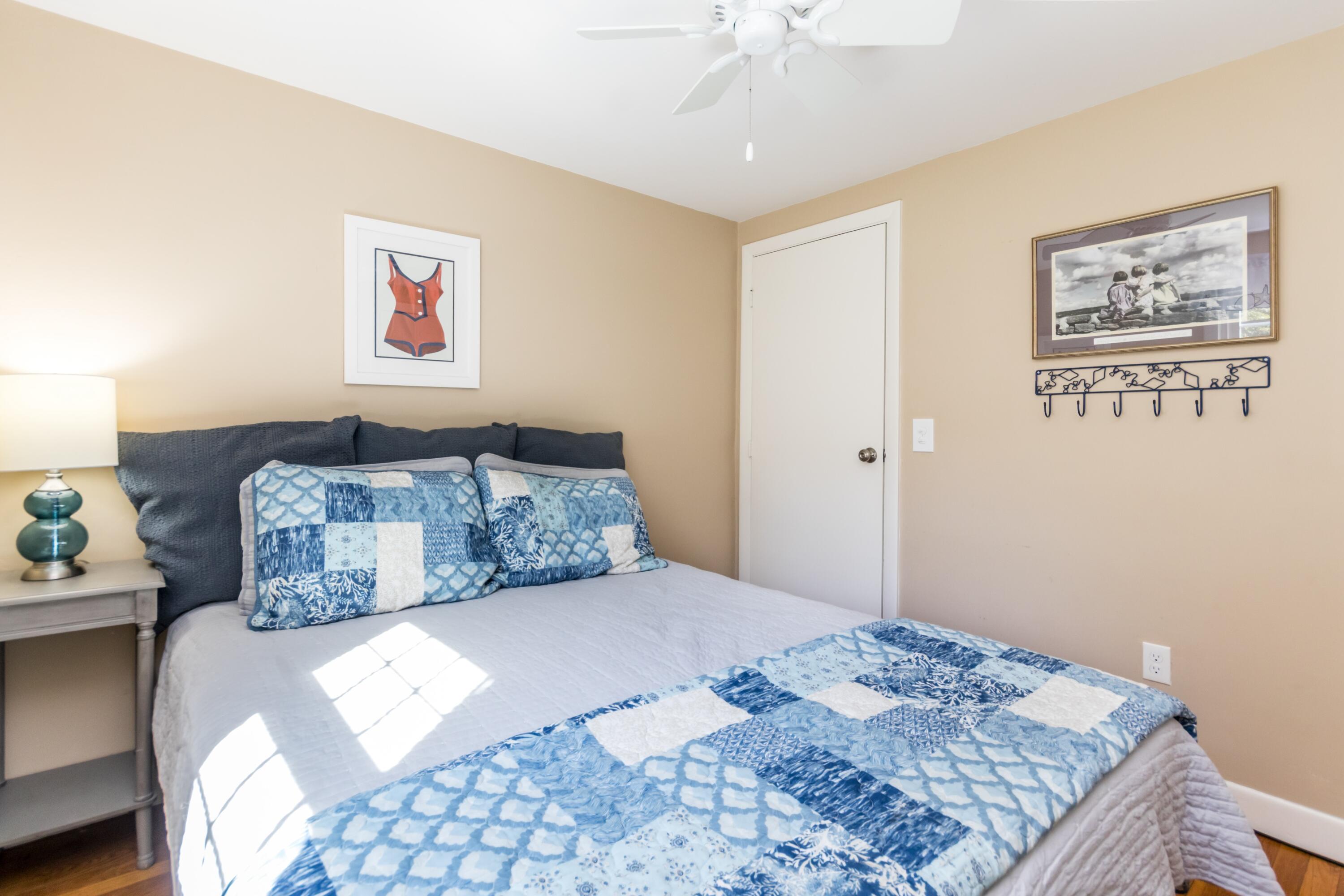 42 Agnes Road South Dennis, MA 02660 - Photo 21 of 36 a bedroom with a large bed and a chandelier