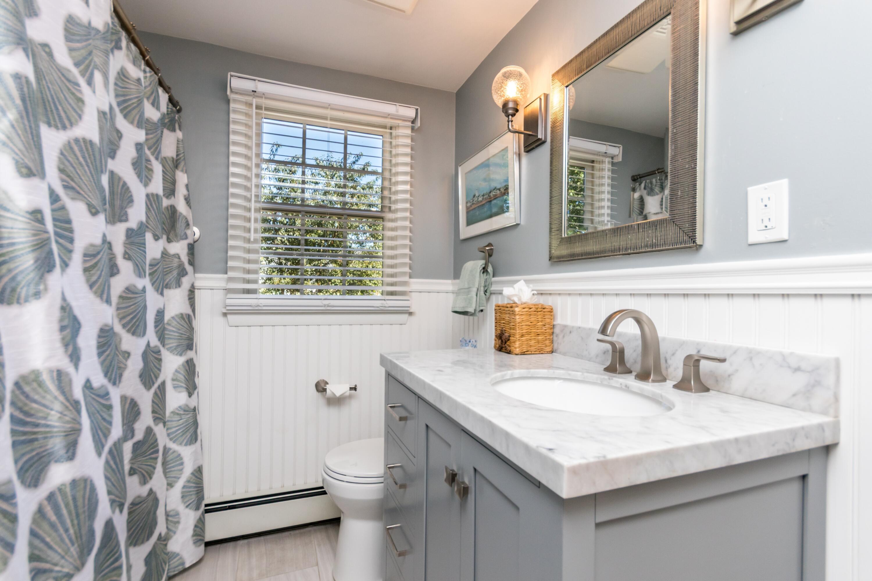 42 Agnes Road South Dennis, MA 02660 - Photo 23 of 36 a bathroom with a granite countertop sink a toilet and a mirror