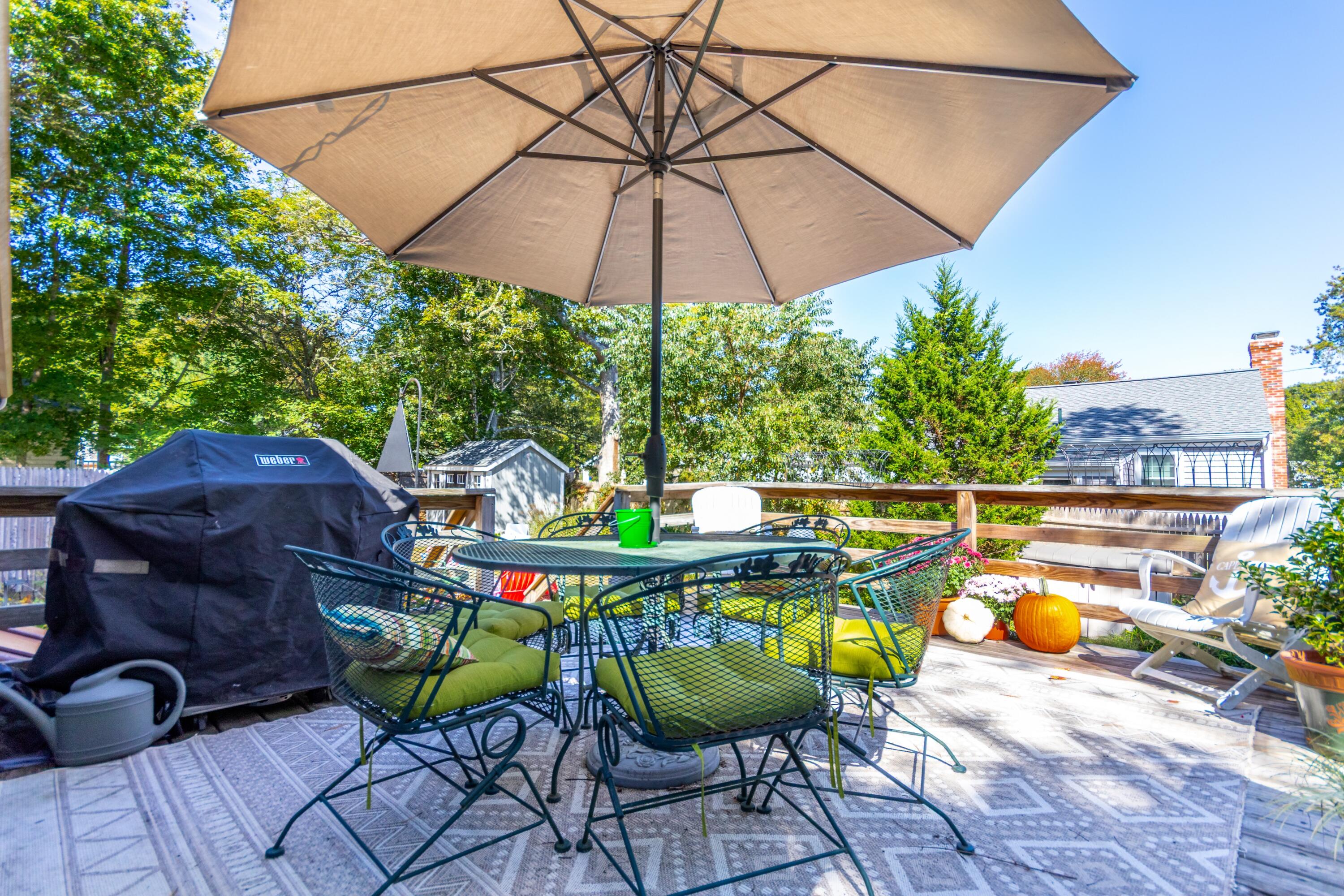 42 Agnes Road South Dennis, MA 02660 - Photo 30 of 36 a roof deck with table and chairs under an umbrella